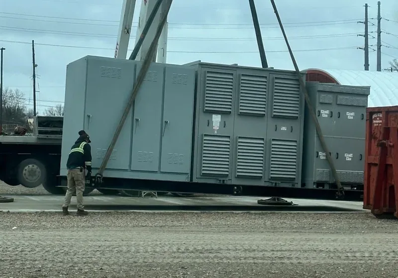 Crane setting a large diesel generator set in place — Sarasota, FL
