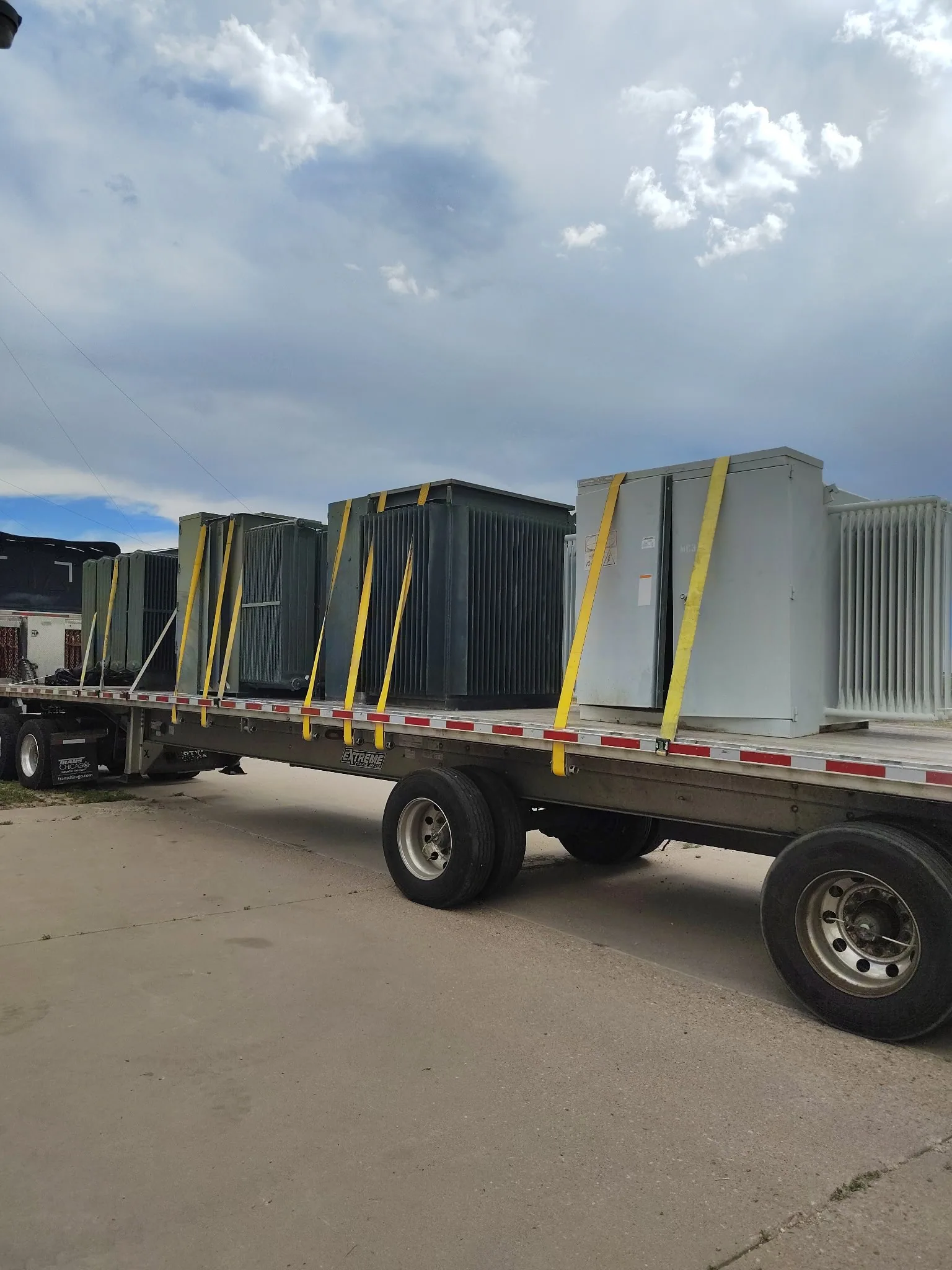 Transformers strapped to a flatbed during load-out