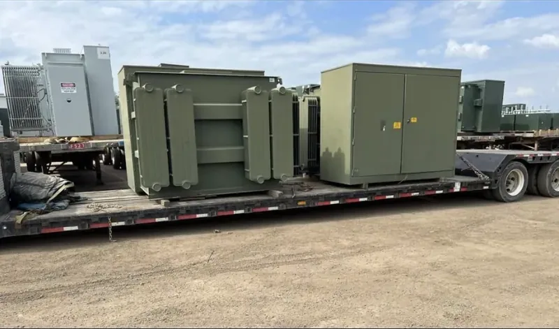 Transformers and enclosures strapped to a flatbed trailer — Sarasota, FL
